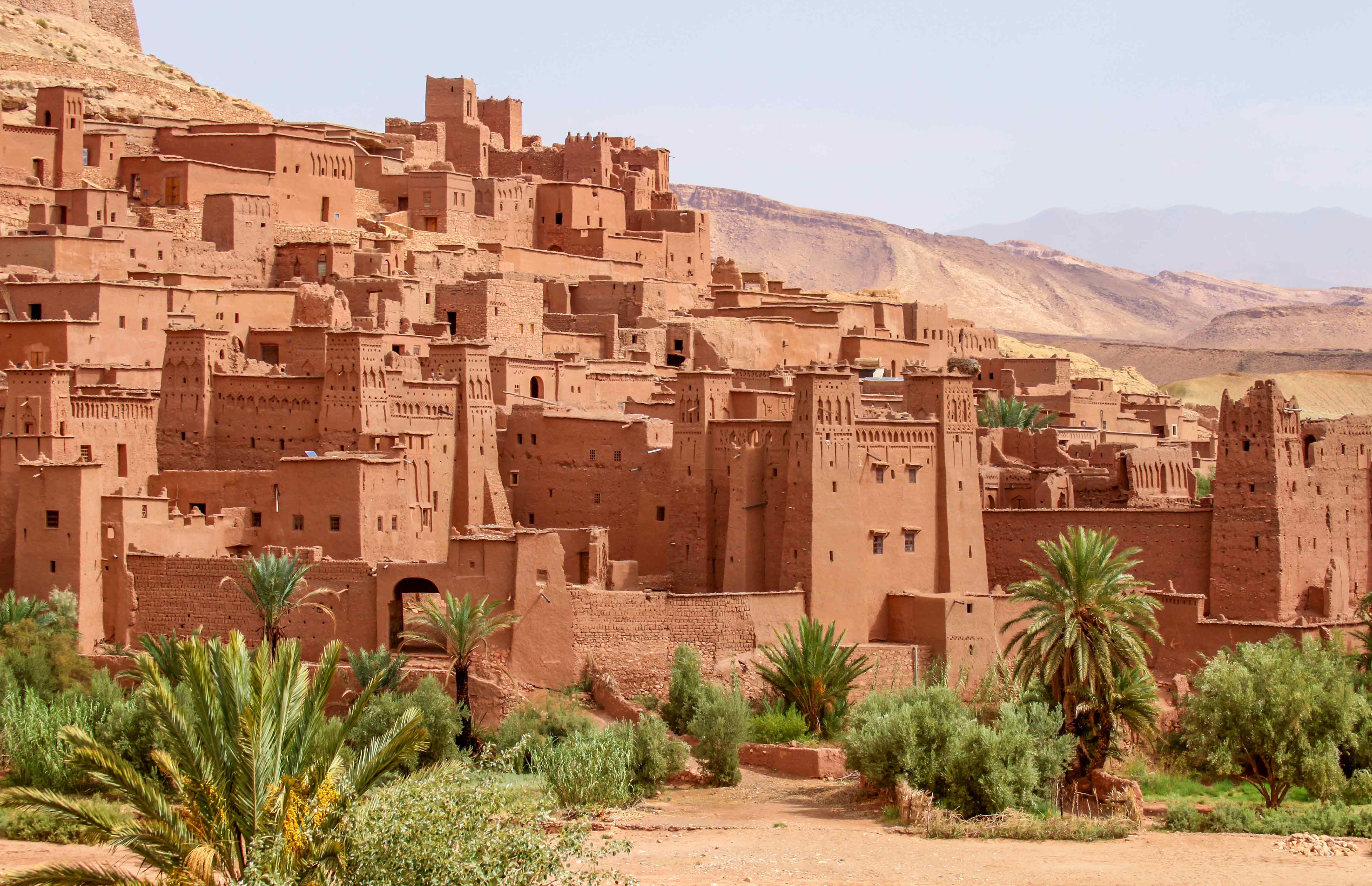 Historic Aït Benhaddou village in Morocco featuring traditional mud-brick architecture and breathtaking Atlas Mountain landscapes.