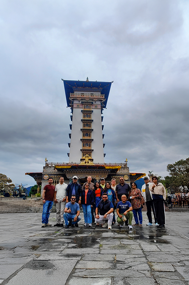 Travel group at Dochula Pass with the iconic Druk Wangyal Tower in Bhutan.