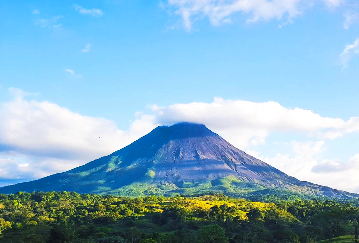 Arenal Volcano surrounded by lush tropical forests in Costa Rica.