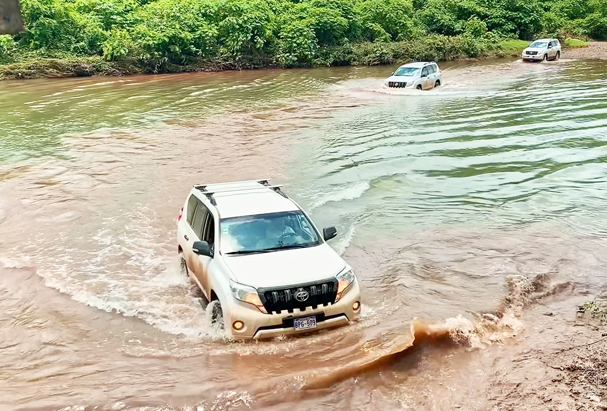 4x4 SUV crossing a river during a Costa Rica overland adventure.
