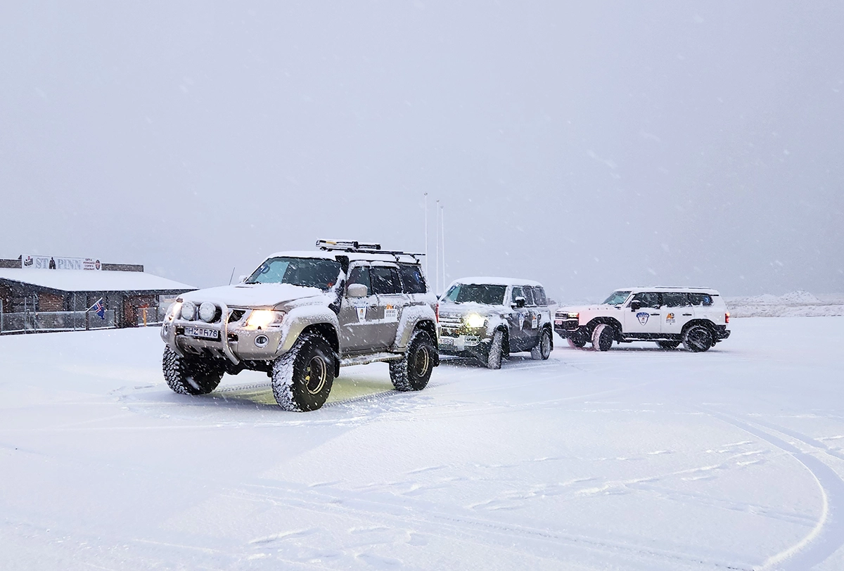 4x4 SUVs driving across Iceland's snowy landscapes.