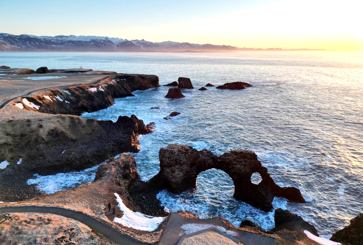 Scenic Icelandic coastline with volcanic rock formations.