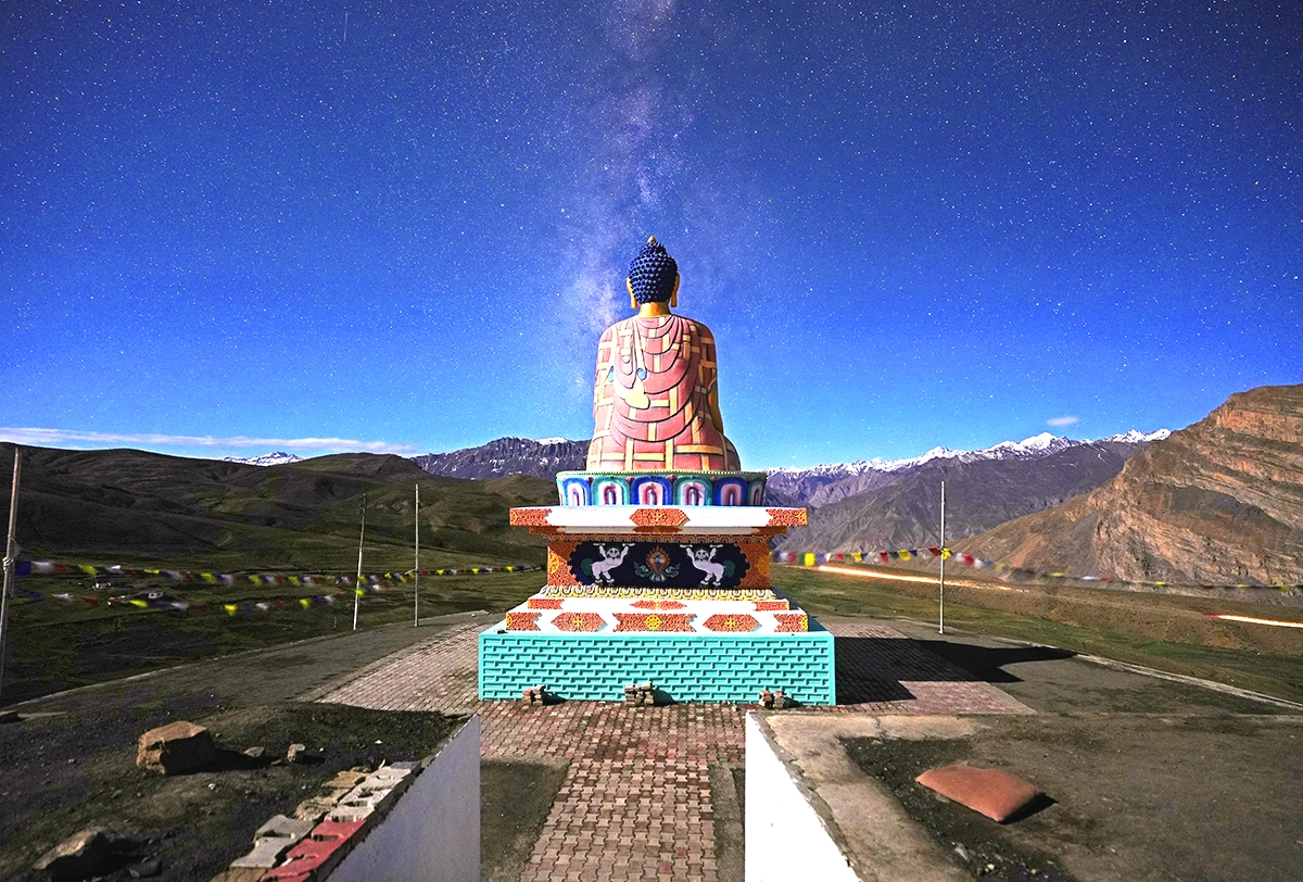 Giant Buddha statue overlooking the scenic landscapes of Ladakh.