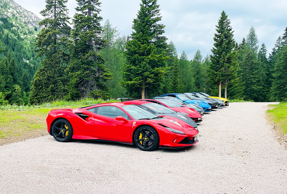 Ferrari lineup on a scenic mountain drive.